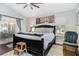 Spacious bedroom features a large bed, bridge-themed art, and an outdoor view, creating a serene and inviting atmosphere at 11506 Clair Pl, Clermont, FL 34711