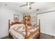 Bedroom with a wooden four-poster bed, antique cabinet, and a double-door closet at 11506 Clair Pl, Clermont, FL 34711