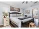 Bright bedroom features a large bed, bridge-themed art, and a comfortable chair at 11506 Clair Pl, Clermont, FL 34711
