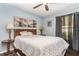 Bedroom with a wooden-framed bed, dark wood floors, and bridge-themed pictures on the light blue walls at 11506 Clair Pl, Clermont, FL 34711