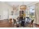 A dining room featuring a modern chandelier, decorative rug, and a large window at 11506 Clair Pl, Clermont, FL 34711
