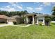 Beautiful single-story home featuring a manicured lawn and an attached two-car garage at 11506 Clair Pl, Clermont, FL 34711