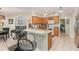 Bright kitchen with granite countertops, white appliances, and a breakfast bar at 11506 Clair Pl, Clermont, FL 34711
