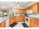 Bright kitchen with granite countertops, white appliances, and light wood cabinetry at 11506 Clair Pl, Clermont, FL 34711