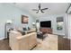 Open-concept living room with a large television and lots of natural light at 11506 Clair Pl, Clermont, FL 34711