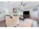 Spacious living room with vaulted ceilings and a large-screen television at 11506 Clair Pl, Clermont, FL 34711