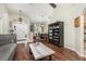 Open-concept home with dark wood flooring, statement shelving, and ample natural light at 11506 Clair Pl, Clermont, FL 34711