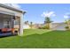 This fenced-in backyard features artificial grass and a covered porch at 1210 Pando Loop, Orlando, FL 32824