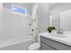 Clean bathroom featuring tile walls, vanity with sink, and shower over tub at 1210 Pando Loop, Orlando, FL 32824