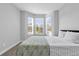 Cozy bedroom featuring a large bay window, carpet, and stylish bedding at 1210 Pando Loop, Orlando, FL 32824