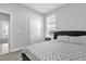 Neutral bedroom featuring a closet, nearby window, and a comfortable bed at 1210 Pando Loop, Orlando, FL 32824