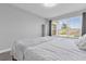 Relaxing bedroom featuring a large window providing natural light and backyard view at 1210 Pando Loop, Orlando, FL 32824