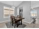 Bright dining room with a modern chandelier, wooden table, and views to kitchen at 1210 Pando Loop, Orlando, FL 32824