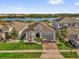 Beautiful single-Gathering home featuring a well-manicured lawn and stunning lake view at 1210 Pando Loop, Orlando, FL 32824