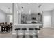 Open-concept kitchen with stainless steel appliances, quartz countertops, and bar seating at 1210 Pando Loop, Orlando, FL 32824