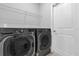 Functional laundry room with LG front load washer and dryer set and wire shelving at 1210 Pando Loop, Orlando, FL 32824