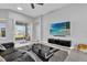 Bright and airy living room with a modern entertainment center and access to the patio at 1210 Pando Loop, Orlando, FL 32824