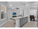 Open kitchen-living room with island and stainless steel appliances at 1210 Pando Loop, Orlando, FL 32824