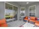 Cozy covered patio with tiled floor, modern furniture, and access to the outdoors at 1210 Pando Loop, Orlando, FL 32824