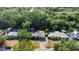 Property aerial showcases the home's location surrounded by lush greenery in a serene neighborhood at 132 W Lauren Ct, Casselberry, FL 32730