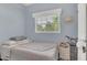Comfortable bedroom with a gray comforter and light blue walls, showcasing a peaceful atmosphere at 132 W Lauren Ct, Casselberry, FL 32730