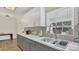 Well-lit kitchen featuring gray bottom cabinets and white top cabinets, plus a modern stainless-steel sink at 132 W Lauren Ct, Casselberry, FL 32730