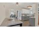 Bright, open kitchen with stainless steel appliances and hardwood floors leads to a connected living space at 132 W Lauren Ct, Casselberry, FL 32730