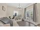 Bright living room with hardwood floors, an air conditioner, white couch, and access to the back yard at 132 W Lauren Ct, Casselberry, FL 32730