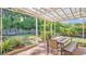 Outdoor patio area provides a tranquil space, complete with a dining table and lush greenery at 132 W Lauren Ct, Casselberry, FL 32730
