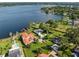 Stunning aerial view showcasing the waterfront property with a red tile roof and lush landscaping at 1322 Palm Dr, Apopka, FL 32703
