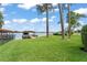 Lush green backyard with waterfront access, including a private dock and boat lift at 1322 Palm Dr, Apopka, FL 32703
