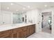 Bright bathroom featuring double vanity sinks with wood cabinetry and a glass enclosed shower at 1322 Palm Dr, Apopka, FL 32703