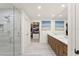 Bright bathroom featuring a glass shower and double sinks near a walk-in closet at 1322 Palm Dr, Apopka, FL 32703