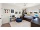 Bright bedroom with white walls, wood floors, ceiling fan and decoratively adorned with a toys and books at 1322 Palm Dr, Apopka, FL 32703