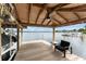 Covered boat dock featuring a ceiling fan and outdoor seating area overlooking the lake at 1322 Palm Dr, Apopka, FL 32703