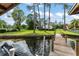 View of the charming backyard, private dock, and boat lift from the water's edge at 1322 Palm Dr, Apopka, FL 32703