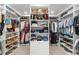 Large walk-in closet with custom shelves, rods, and storage at 1322 Palm Dr, Apopka, FL 32703