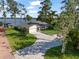 Charming single-story home with a well-manicured lawn and a beautiful brick driveway leading to a 2-car garage at 1322 Palm Dr, Apopka, FL 32703