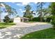 Charming single-story home featuring a paver driveway, a basketball court, and a lush lawn at 1322 Palm Dr, Apopka, FL 32703
