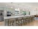A spacious kitchen with light green cabinets, stainless steel appliances, and a large island with seating at 1322 Palm Dr, Apopka, FL 32703