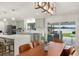 Open kitchen with stainless appliances, island, light green cabinets, and access to the outdoor living space at 1322 Palm Dr, Apopka, FL 32703