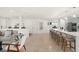 Open-concept layout featuring a spacious kitchen island with seating flowing into the living area at 1322 Palm Dr, Apopka, FL 32703