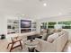 Comfortable living room featuring a modern fireplace, built-in shelves, and ample natural light at 1322 Palm Dr, Apopka, FL 32703