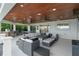 Inviting outdoor living space with an outdoor kitchen, ceiling fans, and an entertainment space to enjoy the view at 1322 Palm Dr, Apopka, FL 32703