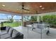 Inviting outdoor living space with an outdoor kitchen, ceiling fans, and a ping pong table for recreation at 1322 Palm Dr, Apopka, FL 32703