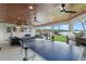 Inviting outdoor living space with an outdoor kitchen, ceiling fans, a tv and entertainment to enjoy the waterfront view at 1322 Palm Dr, Apopka, FL 32703