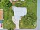 Overhead aerial view of the home showing the roof, driveway, and surrounding greenery at 13245 Shore Dr, Winter Garden, FL 34787