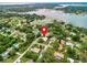 Aerial view of home nestled in a lush, green neighborhood near a beautiful lake at 13245 Shore Dr, Winter Garden, FL 34787