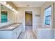 Bathroom boasts double sinks, a large mirror, and a relaxing soaking tub at 13245 Shore Dr, Winter Garden, FL 34787