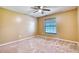 Bedroom with carpet and a ceiling fan; natural light streams through window at 13245 Shore Dr, Winter Garden, FL 34787